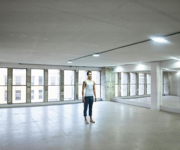 Clean and minimalist interior of a calm yoga studio.